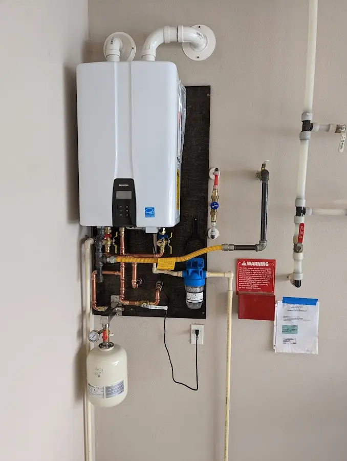 Professional plumber installing copper piping in a Glenwood home